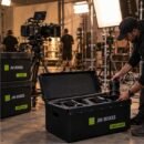 Camera tech pulling cine lenses from a JM Boxes case with custom foam on a film set